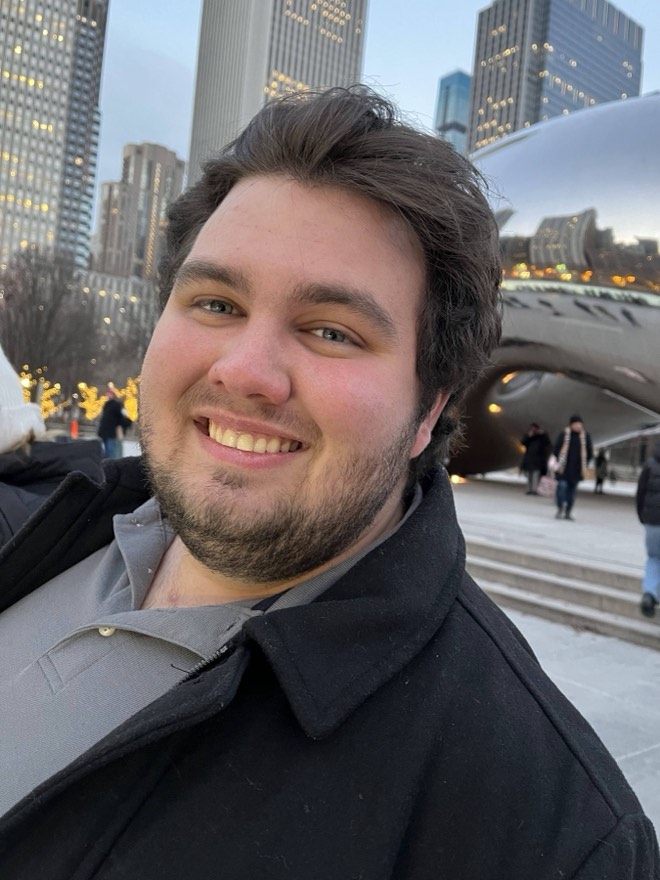 Bibby smiling in front of Cloud Gate in Chicago